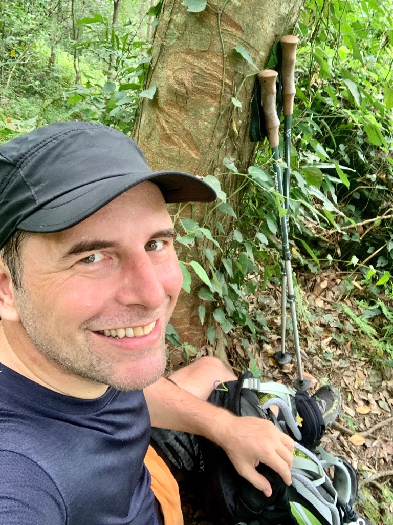 Man sitting on wooded trail